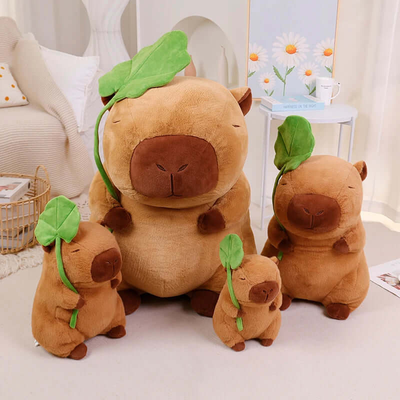 Plush capybara holding a leaf